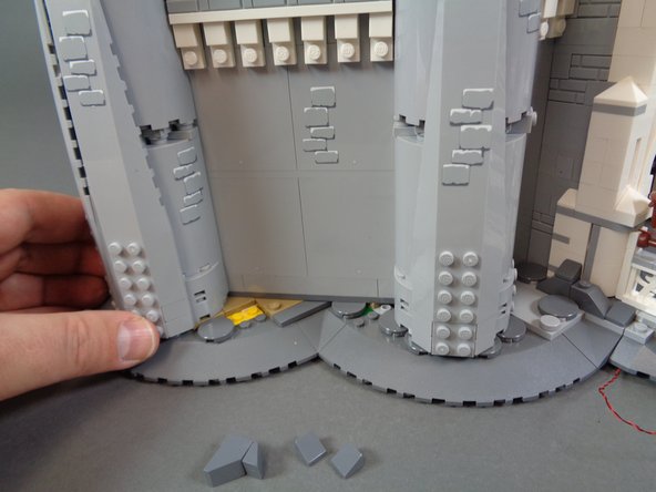 As shown in the first photo for this step, you should now have the yellow and tan pieces visible at the base of the castle wall.