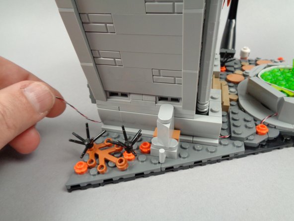 Re-attach the section with the clip next to the town hall, as shown in the second and third photos.