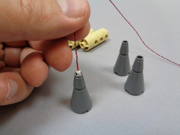 When you have fed the wire through each tower top, the light should look similar to the light shown in the third photo.