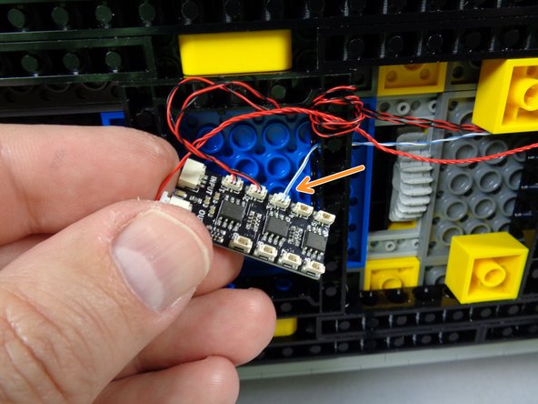 As shown by the orange arrow in the third photo for this step, connect the hood spot light to plug #3 on the BRANCH09X adapter.