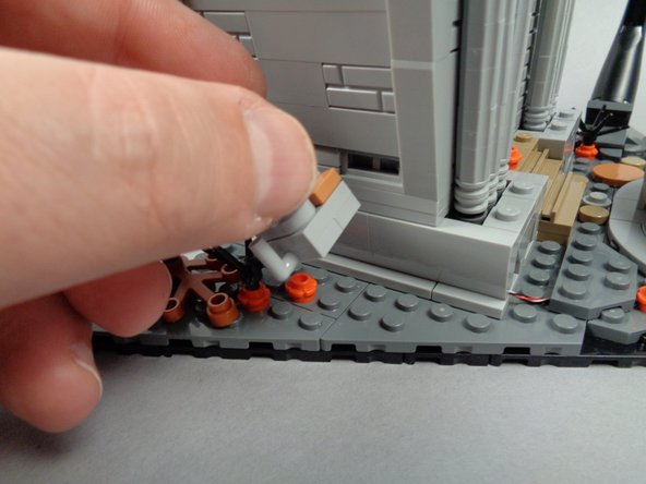 Re-attach the section with the clip next to the town hall, as shown in the second and third photos.