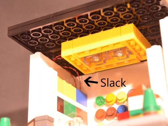 With some planning and a couple of test runs, the slack can be made to fold up beneath or into the space around it, so you won't see the wires in the final installation.