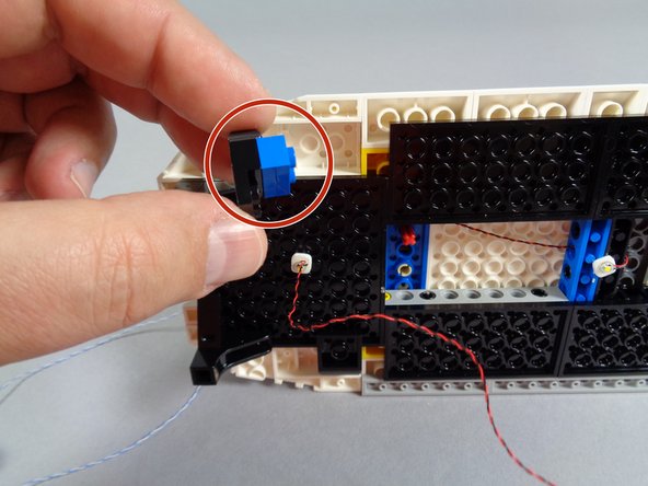 As shown by the green line in the first photo, make sure to attach the rear interior light at least 4 studs behind the front edge of the black roof frame plate.  This space is needed to mount the roof motor in a later step.