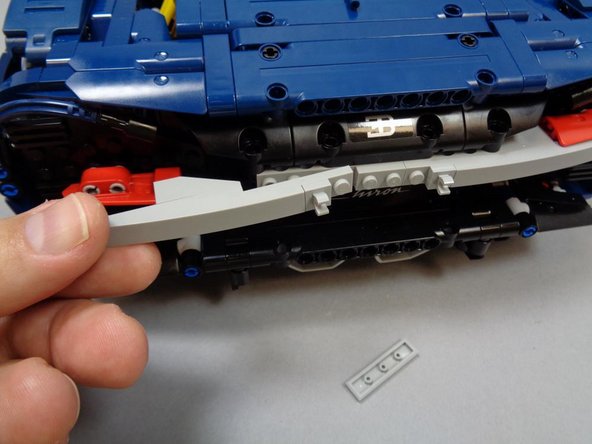 As shown in the third photo, remove the left half of the light bluish gray tail light mount.