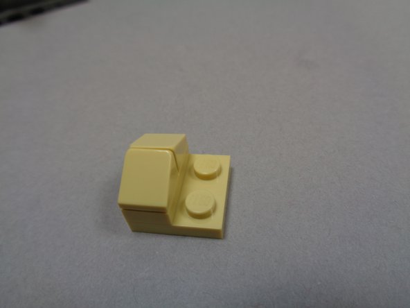 Attach one of the two remaining lights with 6&quot; cable to the bottom of the 2x2 tan plate using a sticky square as shown in the third photo.