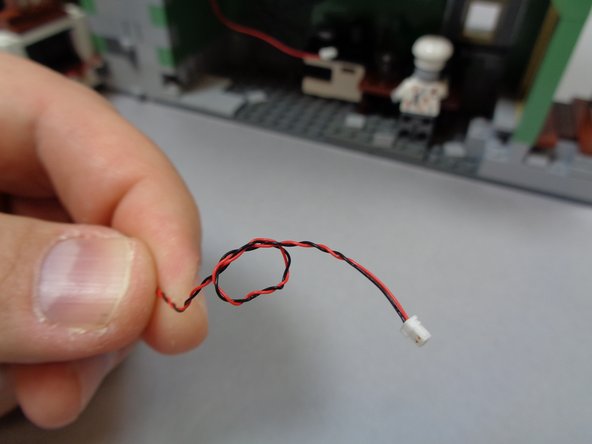 As shown in the second photo, tie a small knot in the wire by the plug.  This will help you identify the light later.