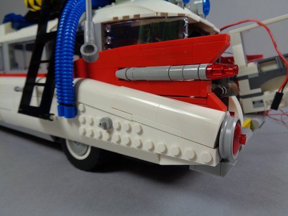 As shown in the photos for this step, you can now re-assemble the pieces of the left rear frame that you removed earlier.  You can also re-attach the hose.