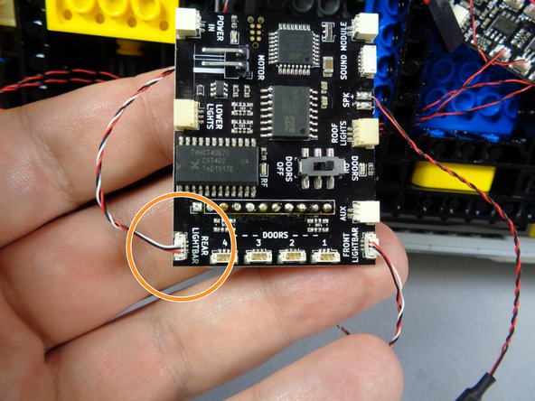 As shown by the green circle in the first photo for this step, connect the control wire for the front lightbar to the FRONT LIGHTBAR plug on the main controller.