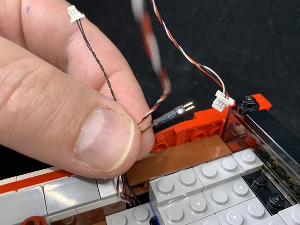 Carefully run the black wire as shown in the second photo (purple lines) by removing &quot;boat studs&quot;, running the wire between studs underneath, then re-attaching the &quot;boat studs&quot;.