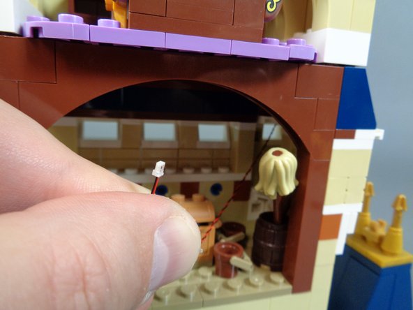 As shown by the third photo, reach inside the magic room and pull the light wire down into the room.