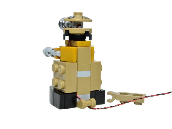 Carefully pull the wire through the hole in the clip until the wire is snug against the side of the robot.