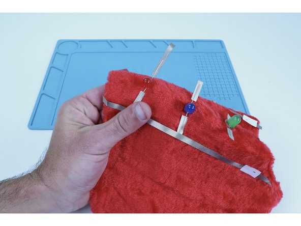 Measure and cut two pieces of Maker Tape for each LED you plan on using. We used 6 LEDs in our project. So, we cut 12 pieces of Maker Tape. These pieces should be approximately 2x the length of the LED legs themselves.