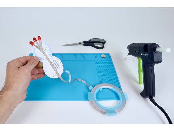 Path G: On the "long leg side", connect a piece of Maker Tape to the spot where the three LED legs come together. Guide it straight down the center of the project to the back end of the project but don't cut the tape yet.