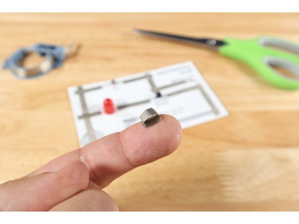 Cut a small 3/4&quot; piece of Maker Tape and roll it into a sticky-side-out  tape loop. Stick this loop atop the battery end of Tape Path A as shown in the tape loop diagram on your template.