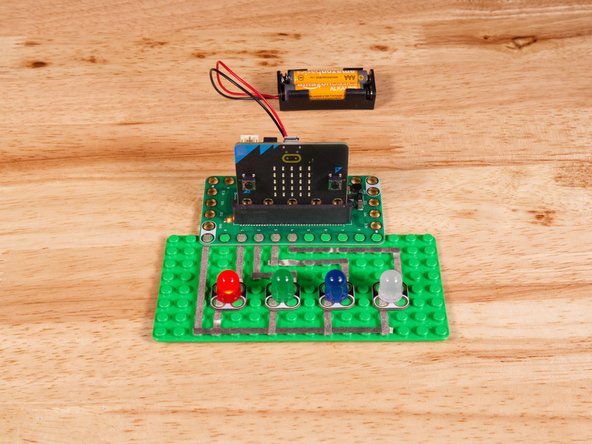 Connect the Negative (-) sides of the LEDs to a Ground (GND) hole on the Bit Board.