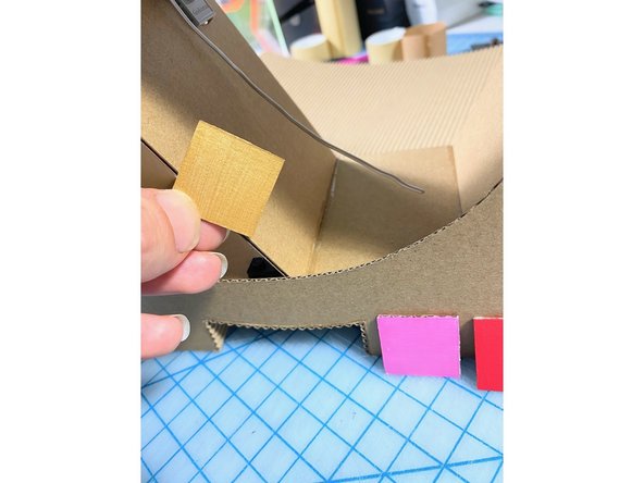 We tested our acrylic paints on cardboard squares to choose colors. (Sometimes paint shows up differently when you paint it on the brown cardboard color.)