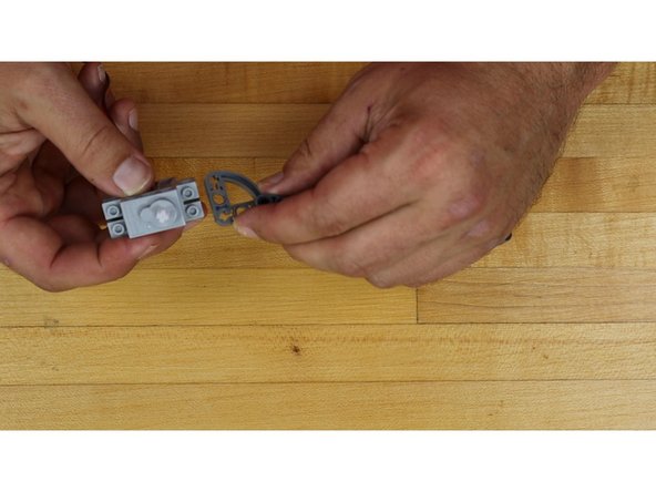 Slide the end of the gate arm onto the shaft of the Servo.