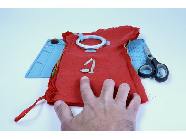 Stick your battery atop the tape loop so that the positive (+) side faces UP.