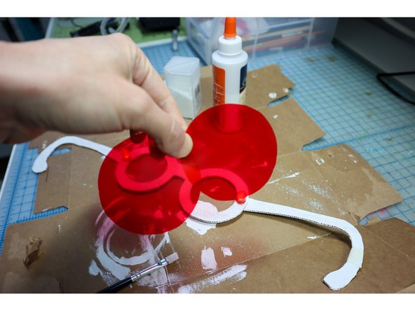 Use hot glue to glue them to the back of the frames.