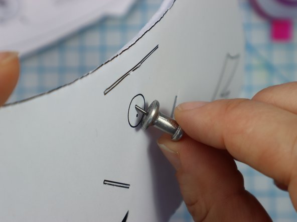 Use a push pin to make two holes for the LED's legs. When the push pin is inside the felt, rotate it around a bit to make the hole larger and easier to see.