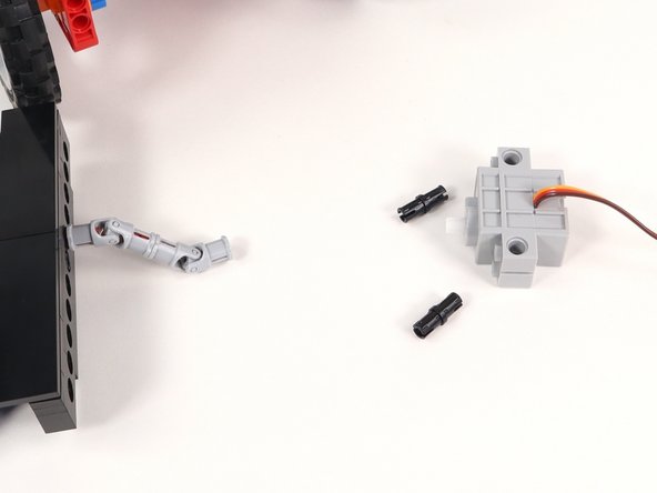 Insert two black pins into the servo on the side where the wires connect.