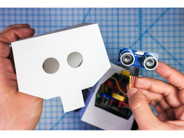 Place the Distance Sensor into the eye circles as shown.