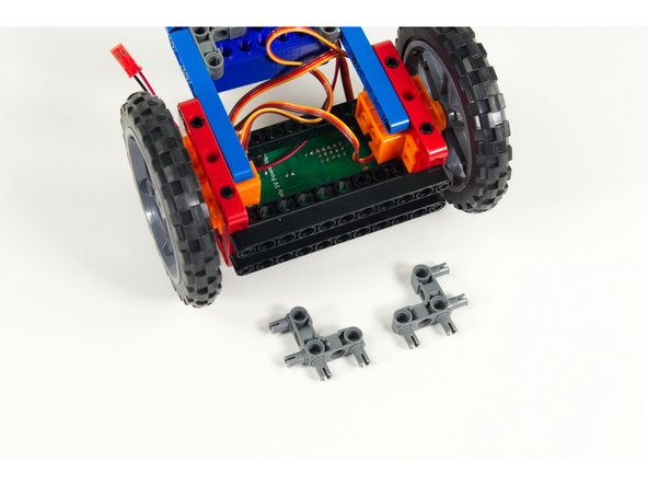 Turn the Rover upside down. We'll add two 90 degree connectors to the blue rear stabilizer beams as show.