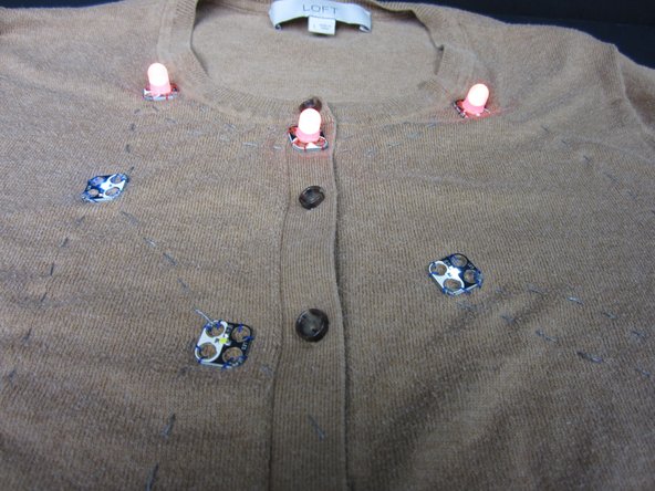 First, hook up your Screw Terminal to the Positive and Ground pins on the Blink/ Fade Board. Then screw in your battery holder.