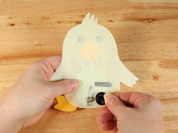 Make sure the Positive side of the Battery is facing upwards, with the Negative side stuck down to the tape.