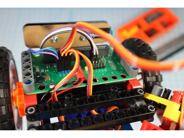 Connect the gray servo motor to pin 15 using the blue (5V) pin headers.