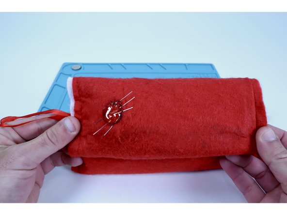 Once you verify that the 6 LED legs are not touching/separated by fabric, use a glue gun to fill the circle you just outlined with a blob of hot glue.