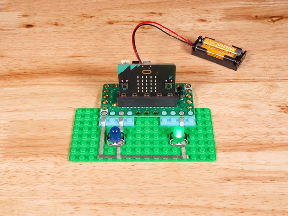 Connect the Negative (-) sides of the LEDs to a Ground (GND) hole on the Bit Board.