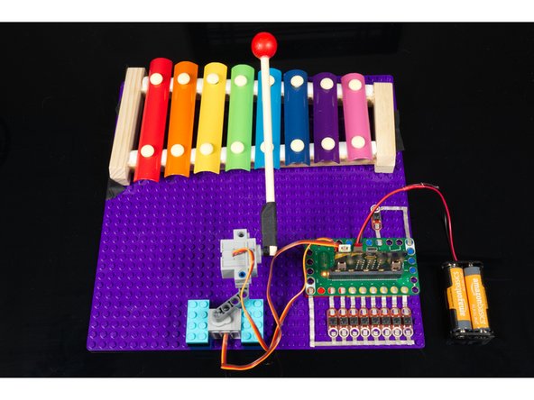 You can add more functions to your code and then change it so Pin 15 triggers the song you want. (Or add more buttons to have a larger song selection.)