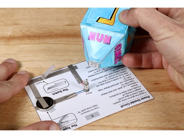 Apply a small dab of hot glue TO the flat top of the motor weight. Do not put so much hot glue in place that it drips below the weight. This will cause the motor spindle to not spin freely.