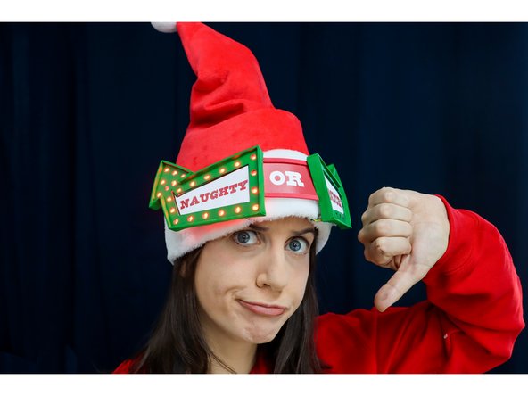 Use Hot Glue to glue the Arrows to the hat, with the &quot;OR&quot; sign in the center.