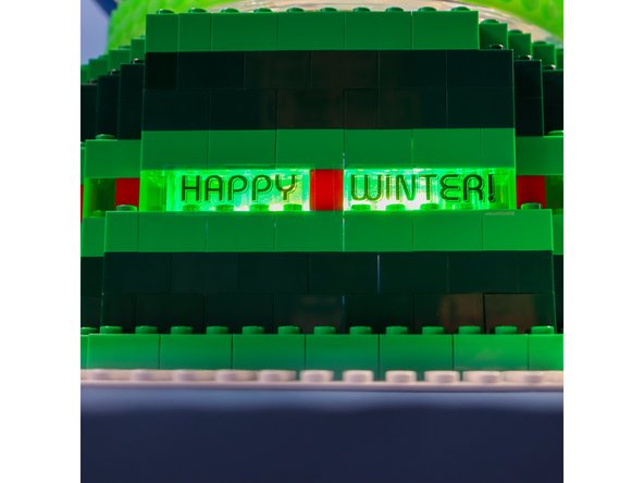 I used my label maker to make transparent words that I placed over the clear LEGO. There is a NeoPixels stick behind the letters to illuminate them.