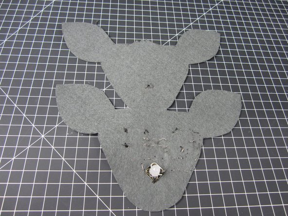 Cut a hole or slit in the second layer of your face for the LED to go through.