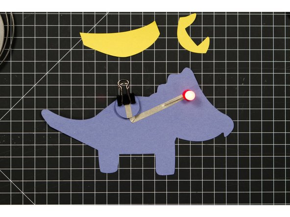 Use a binder clip to hold the battery in place.