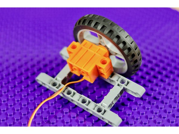 You could also use a pulley and rubber band to drive a shaft.