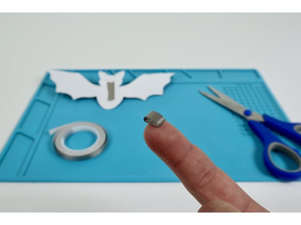 Place that tape loop atop the center of the taped area that is now atop the Long LED Legs.