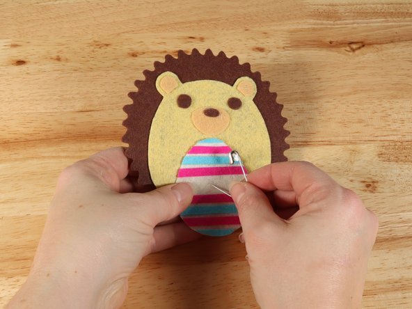 Use a safety pin or a push pin to poke two holes through the felt for the LED legs to go through.