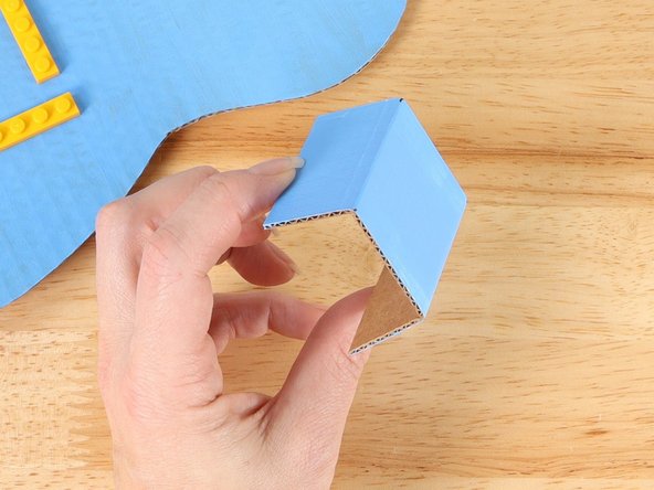 Using a straight edge like a ruler, fold the battery compartment along the lines to form a u-shape.