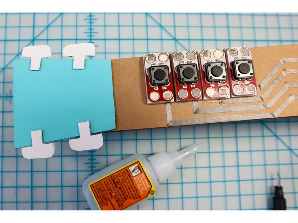 Place the buttons on top of the LEGO with the negative side facing the edge.