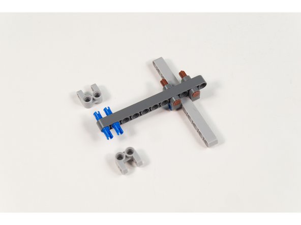 Add 2 LEGO Cross Block 2 x 2 Split (Axle / Twin Pin) as shown.