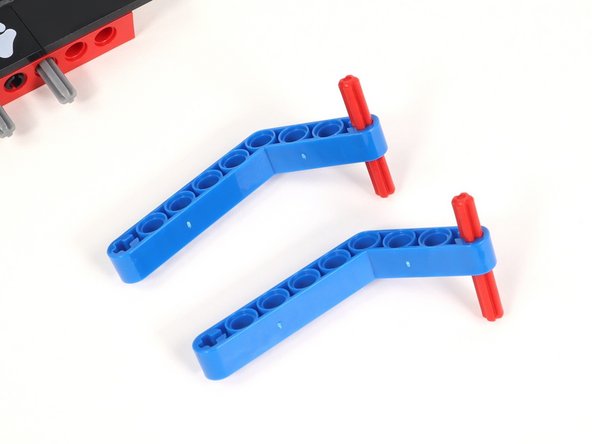 Since the bent blue beam is not the same length on each side, you can play around with the placement of the axle based on your needs.