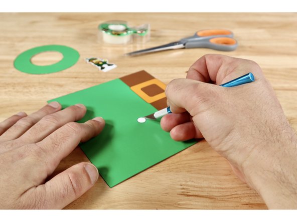 You will need a generous hole through the spot on the tube that is even with the servo axle. This spot is marked on the tube template and it's easier to remove it now before you create the tube shape. Use an Xacto Knife or another tool you favor to cut that small hole out of the tube.