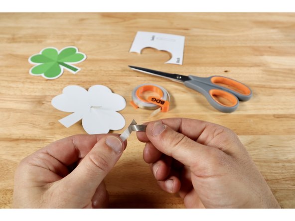 Measure, cut, and peel a piece of Maker Tape that is about 2x the length of the short LED leg. This SHOULD be the leg that is going through the lower hole. Set aside; ready for use.