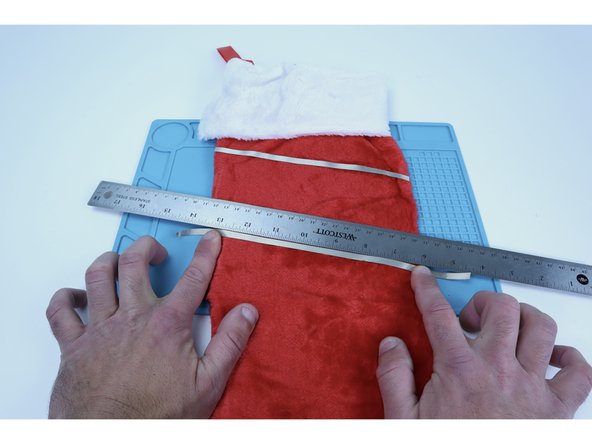 To put some space between the first two circuit paths and these next two, lay one of the rulers over the top of the last Maker Tape path you placed and use the opposite edge to guide the placement of a new path.