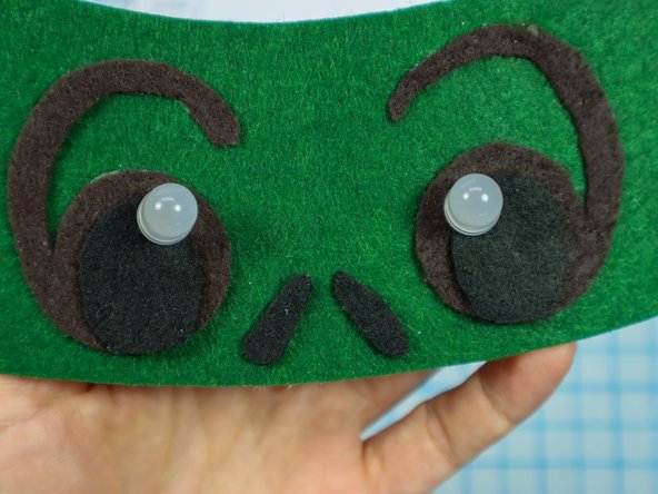 Insert each LED through the holes with the longer, positive leg in the top hole.