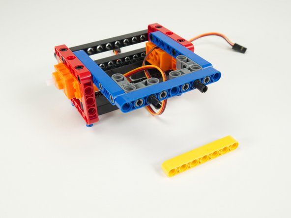 Place two black pins into the beam we just added, in the third hole from each end.